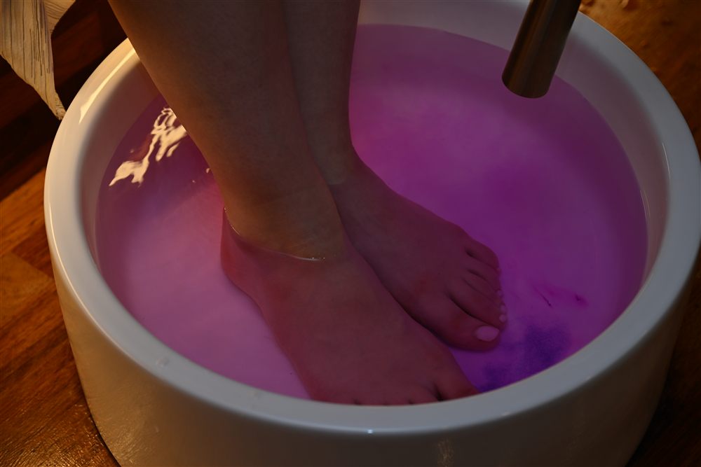 Feet resting in a warm aroma foot bath